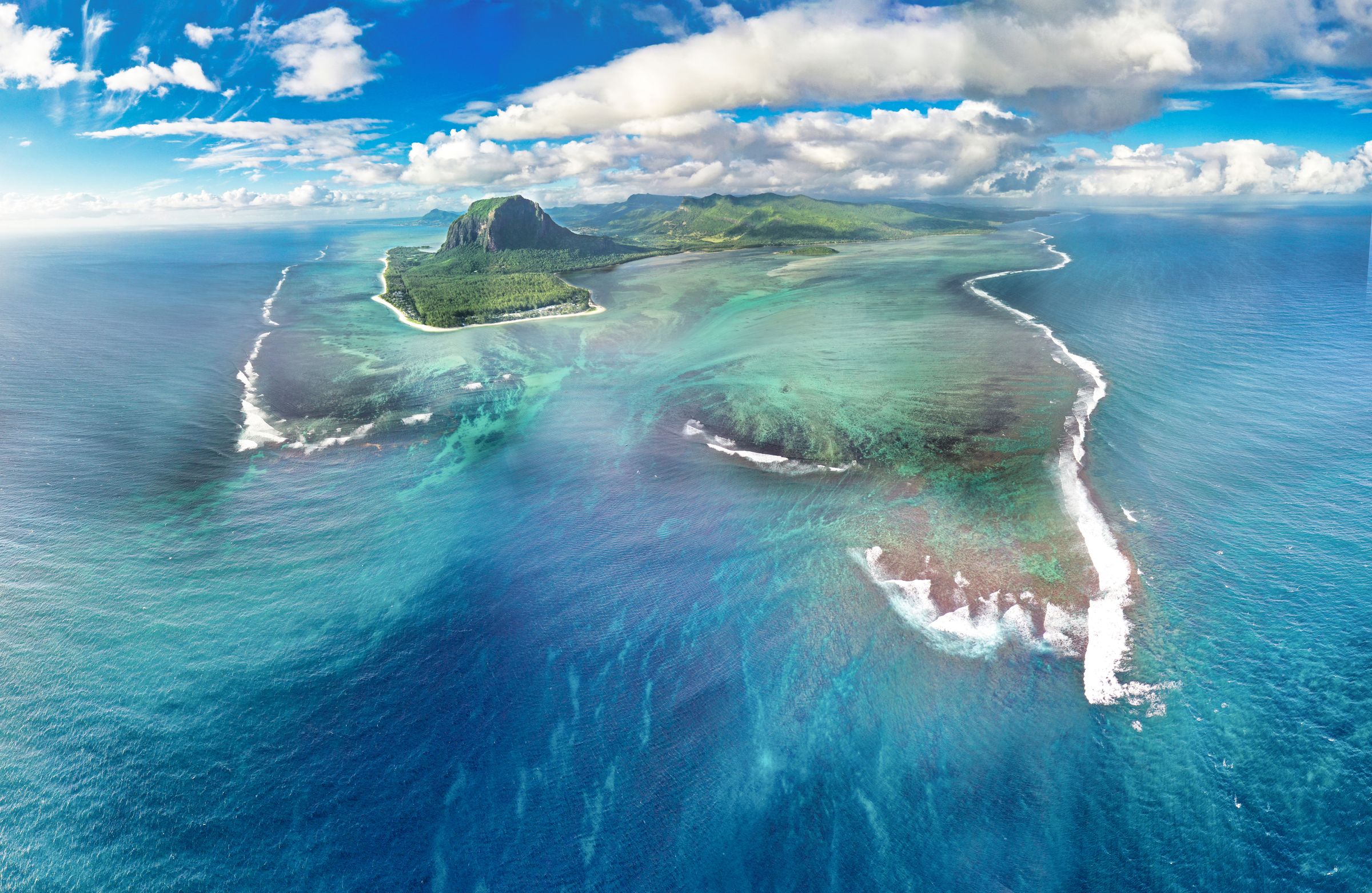 Le Morne Brabant rising above the turquoise lagoons and coral reefs of Mauritius